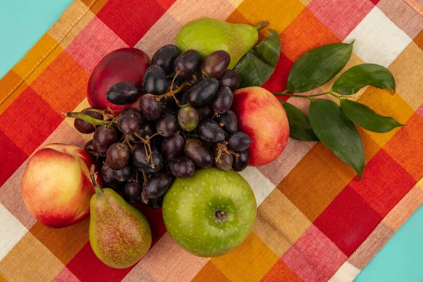 Petrovdanski Ukusi top view fruits as grape peach apple pear with leaves plaid cloth background 141793 27932